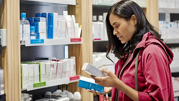 Woman with medicine in pharmacy