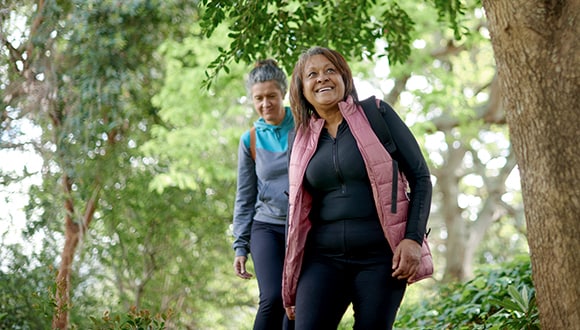 Mother and daughter walking in bushland