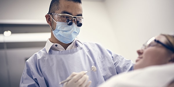 A dentist servicing a patient