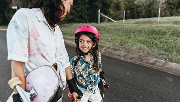 Mother and daughter skateboarding to connect with each other