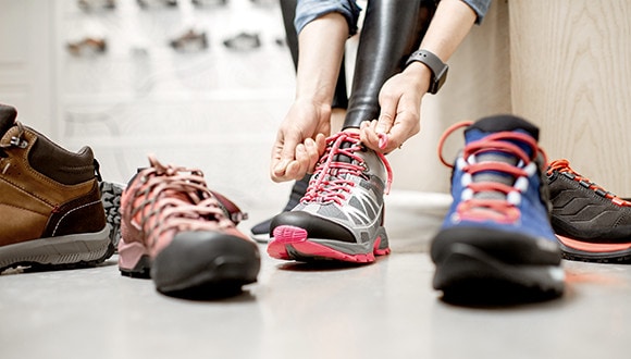 A woman trying on a range of sports shoes