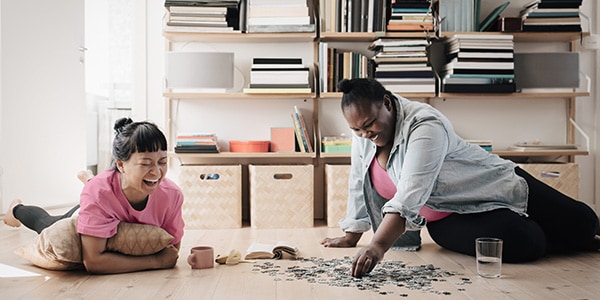 Friends doing a puzzle as a way to look after their mental wellbeing