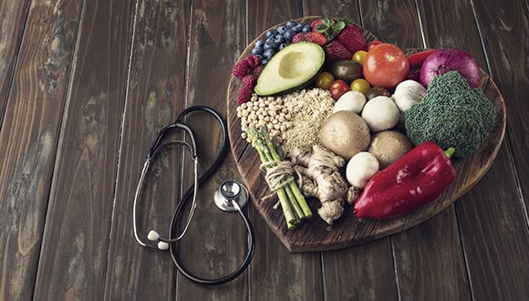 Photo of a heart shaped plate with an assortment of fruits and vegetables