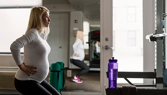 Woman exercising while pregnant with a low impact regime