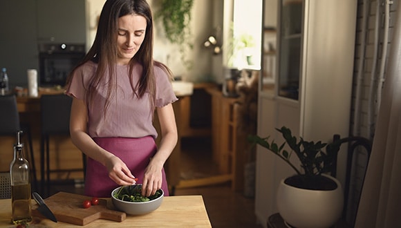 Woman with orthorexia preparing a healthy meal