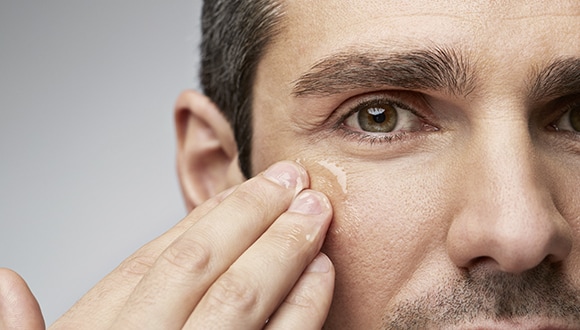 A man applying skin care product to his face