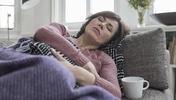 Woman sleeping on the lounge after learning about what are hormones